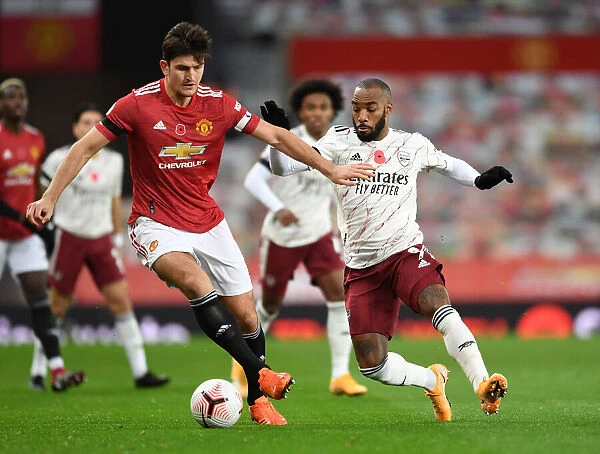 Clash at Old Trafford: Arsenal's Lacazette Pressures Maguire Amid Empty Stands (Manchester United vs Arsenal, 2020-21)