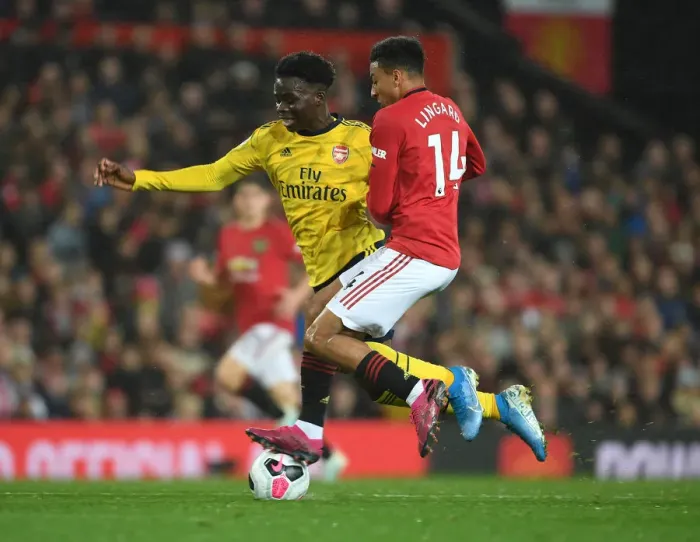 Framed Print : Clash of the Red and Blues: Bukayo Saka vs Ashley Young - Battle at Old Trafford (Manchester United vs Arsenal 2019-20)