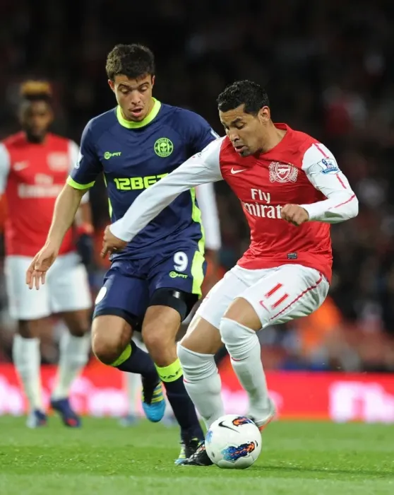 Framed Print : Clash of Santos: Arsenal's Andre Faces Wigan's Franco in Premier League Showdown
