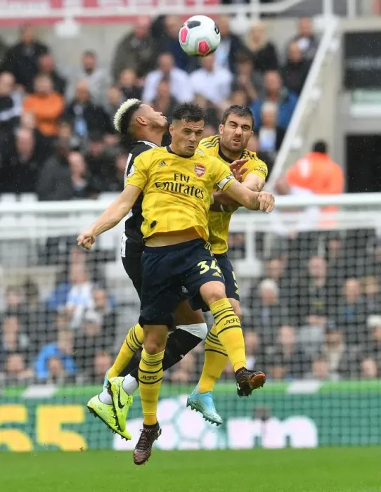 Framed Print : Clash at St. James Park: Xhaka and Sokratis Battle for Control in Newcastle United vs. Arsenal FC, Premier League 2019-20