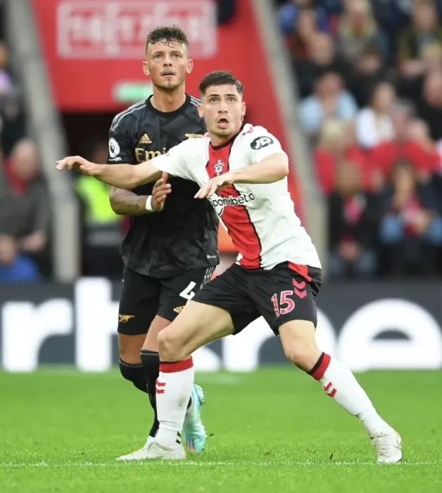 Framed Print : Clash at St. Mary's: Arsenal's Ben White Faces Off Against Southampton's Romain Perraud in Premier League Showdown