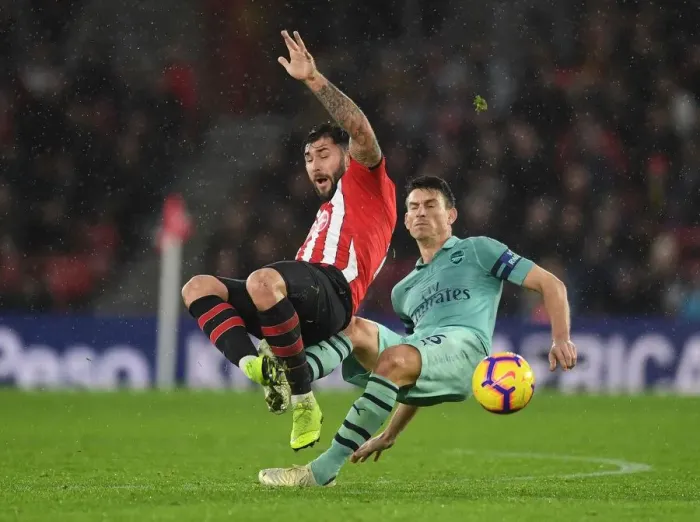 Framed Print : Clash at St. Mary's: Koscielny vs. Austin in Southampton v Arsenal Football Showdown