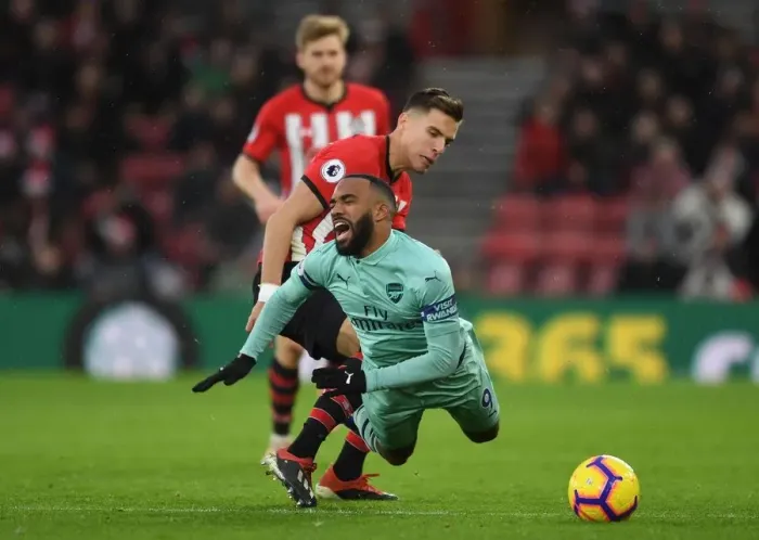 Framed Print : Clash at St. Mary's: Lacazette Fouls by Bednarek in Southampton vs Arsenal Premier League Encounter Framed Print : Clash at St. Mary's: Lacazette Fouls by Bednarek in Southampton vs Arsenal Premier League Encounter