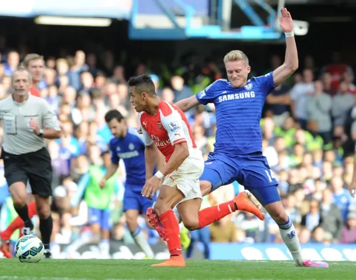Framed Print : Clash at Stamford Bridge: Alexis Sanchez Fouls by Schurrle in Chelsea vs Arsenal Premier League Match (2014-15) Framed Print : Clash at Stamford Bridge: Alexis Sanchez Fouls by Schurrle in Chelsea vs Arsenal Premier League Match (2014-15)