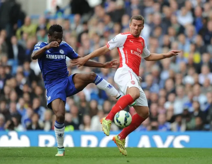 Framed Print : Clash at Stamford Bridge: Lukas Podolski vs. John Mikel Obi, Premier League Showdown