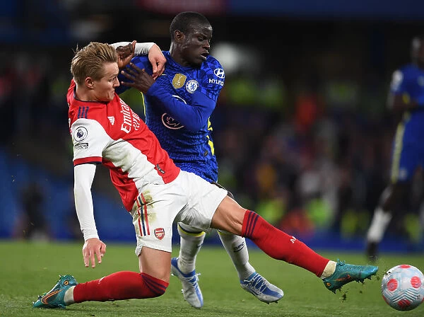 Clash at Stamford Bridge: Martin Odegaard Tackles N'Golo Kante in Premier League Showdown (Chelsea vs Arsenal 2021-22)