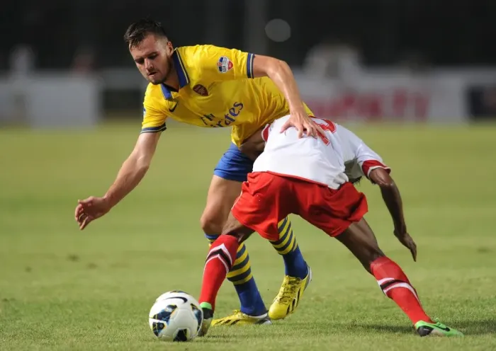 Framed Print : Clash of Stars: Jenkinson vs. Sanadi in Arsenal's Encounter with Indonesia All-Stars
