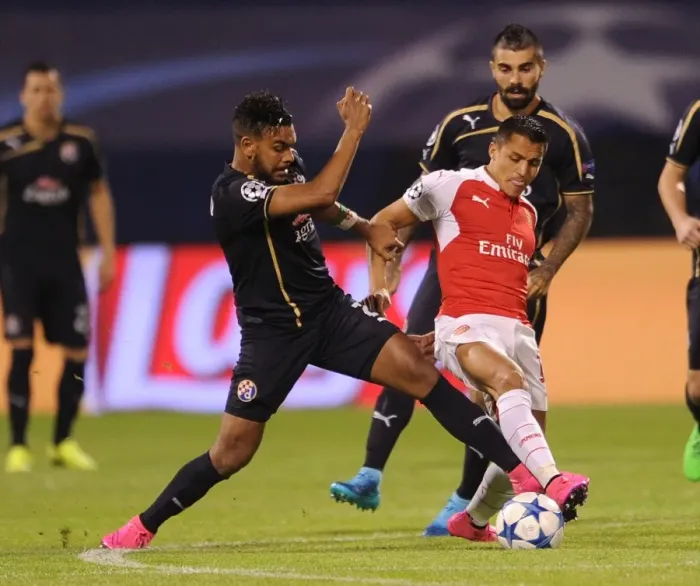 Framed Print : Clash of Stars: Sanchez vs. Soudani - Arsenal's Alexis Sanchez Goes Head-to-Head with Dinamo Zagreb's El Arabi Hilal Soudani