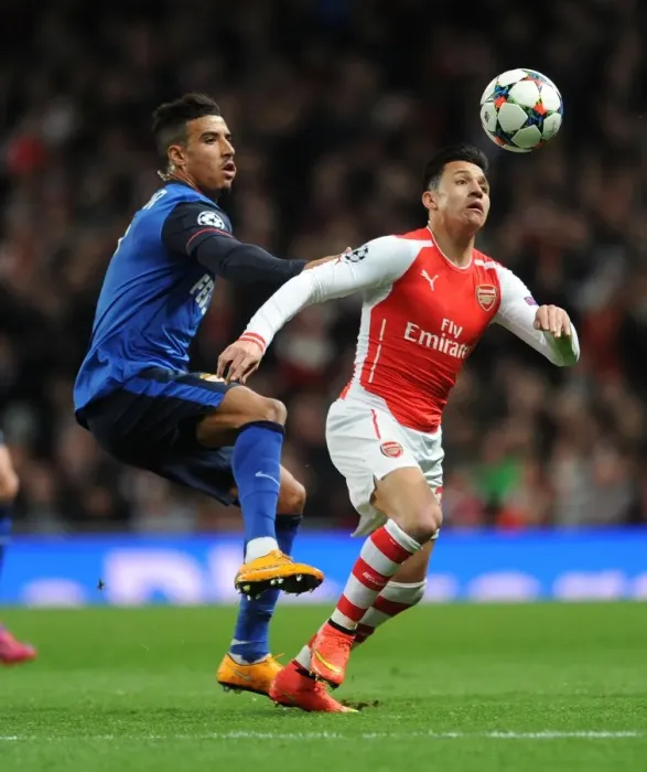 Framed Print : Clash of Stars: Sanchez vs. Dirar in Arsenal's UEFA Champions League Battle against Monaco