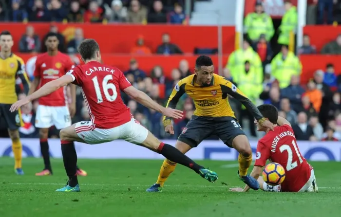 Framed Print : Clash of Titans: Coquelin Stands Firm Against Manchester United's Midfield Duo Framed Print : Clash of Titans: Coquelin Stands Firm Against Manchester United's Midfield Duo