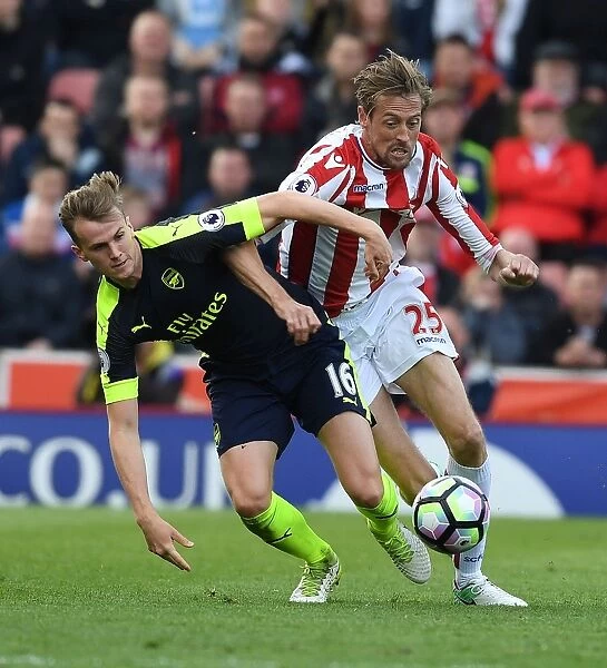 Clash of Titans: Holding vs. Crouch - A Battle at the Heart of Stoke City vs. Arsenal, Premier League