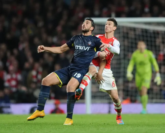 Framed Print : Clash of Titans: Koscielny vs. Pelle in Arsenal vs. Southampton Premier League Showdown