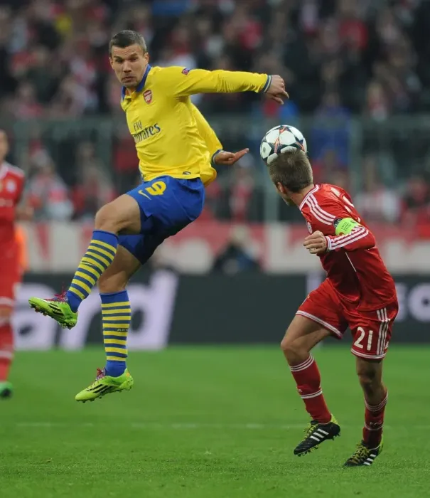 Framed Print : Clash of Titans: Lukas Podolski vs. Philipp Lahm - FC Bayern Munich vs. Arsenal, UEFA Champions League