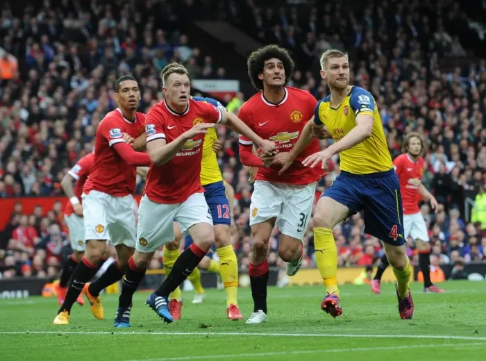 Framed Print : Clash of Titans: Mertesacker vs. Jones & Fellaini - Manchester United vs. Arsenal, Premier League 2014-15: A Battle of Strength and Skill