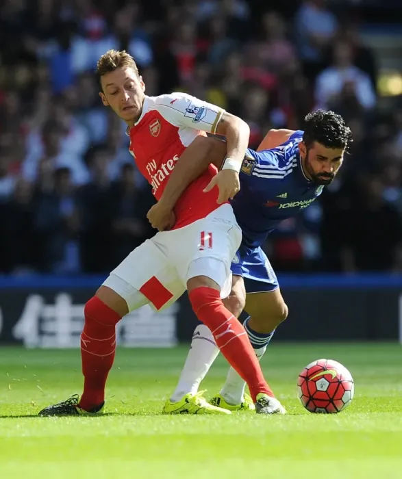 Framed Print : Clash of Titans: Ozil vs Costa - Premier League Showdown: A Battle Between Arsenal's Ozil and Chelsea's Costa