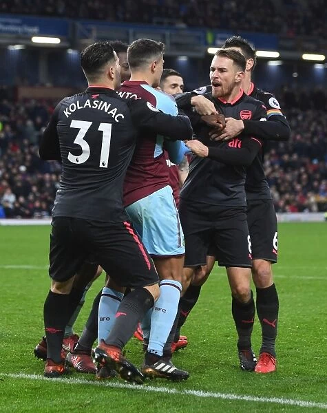 Clash at Turf Moor: Ramsey and Lowton Tangle in Intense Burnley vs. Arsenal Match