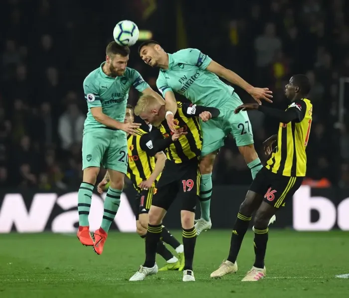 Framed Print : Clash at Vicarage Road: Mustafi and Mavropanos Go Head-to-Head Against Watford's Hughes