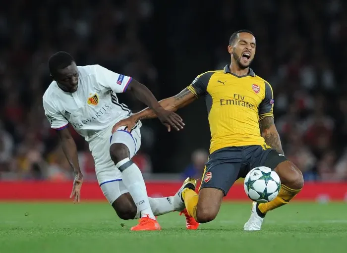 Framed Print : Clash of Wings: Theo Walcott vs. Adama Traore in Arsenal's UEFA Champions League Showdown against FC Basel Framed Print : Clash of Wings: Theo Walcott vs. Adama Traore in Arsenal's UEFA Champions League Showdown against FC Basel