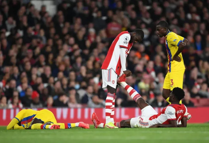 Framed Print : Comrades in Arms: Pepe Consoles Injured Partey on the Arsenal Field (2021-22)