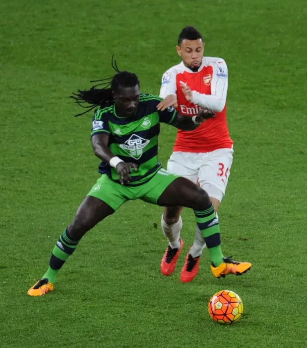 Framed Print : Coquelin vs Gomis: Intense Battle in Arsenal's Premier League Clash Against Swansea City Framed Print : Coquelin vs Gomis: Intense Battle in Arsenal's Premier League Clash Against Swansea City