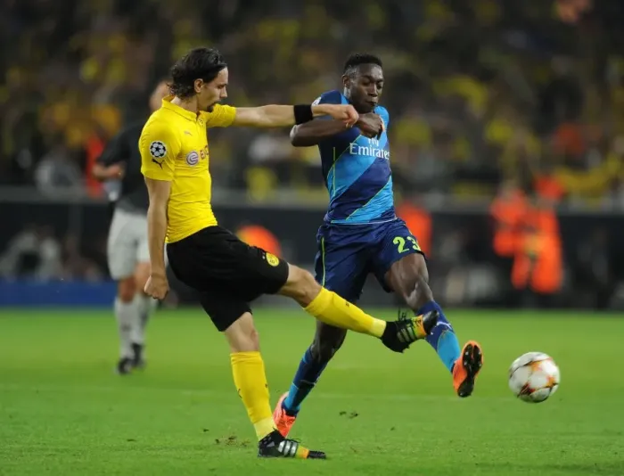 Framed Print : Danny Welbeck vs. Neven Subotic: Intense Battle in Borussia Dortmund vs. Arsenal UEFA Champions League Clash