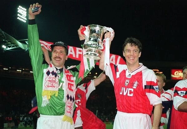 David Seaman and David O'Leary hold aloft the FA Cup Trophy after the game