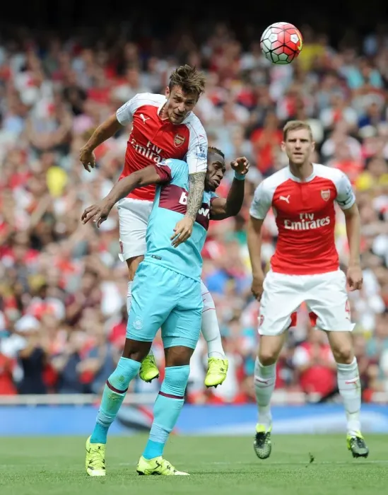 Framed Print : Debuchy Soars Over Sakho: Arsenal vs. West Ham Clash, 2015-16
