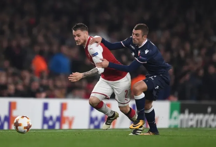 Framed Print : Debuchy vs. Krsticic: A Europa League Battle at Emirates Stadium