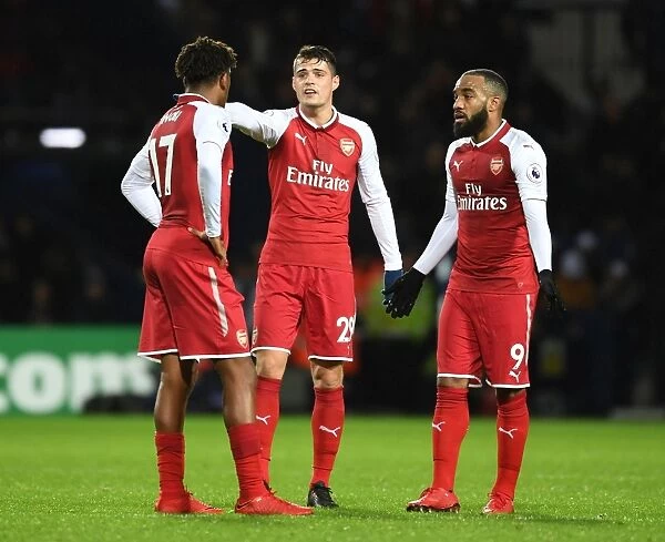 Deep in Thought: Lacazette, Iwobi, and Xhaka's Intense Discussion on the Arsenal Sideline