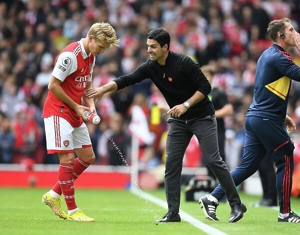 Deep in Thought: Mikel Arteta and Martin Odegaard's Intense Discussion at Emirates Stadium - Arsenal vs. Tottenham (2022-23)