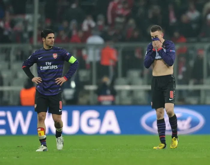 Framed Print : Dejected Arsenal: Mikel Arteta and Laurent Koscielny After UEFA Champions League Defeat to Bayern Munich