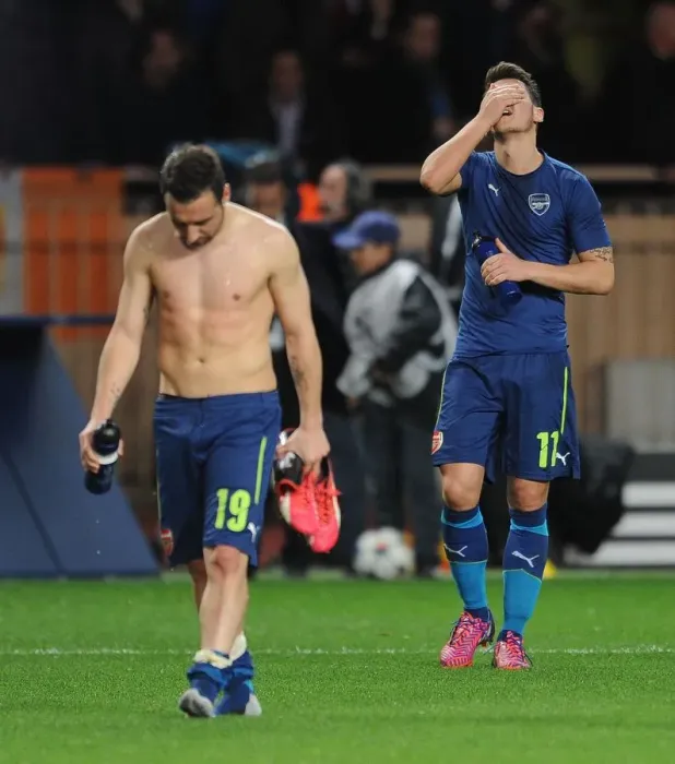 Framed Print : Departing Duo: Ozil and Cazorla Leave the Field after Monaco vs. Arsenal UEFA Champions League Clash