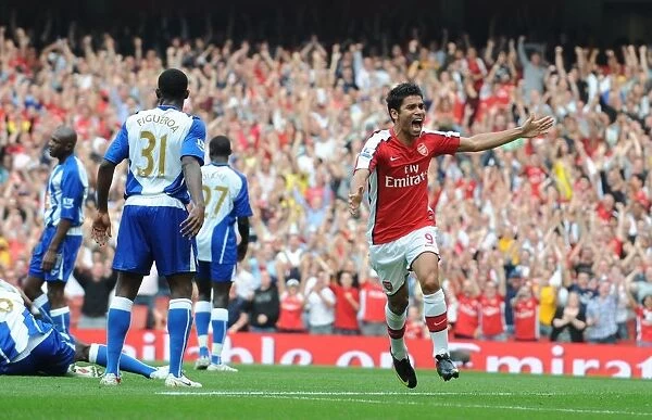 Eduardo's Delight: Emmanuel Eboue Scores Arsenal's Third Goal in 4-0 Victory over Wigan Athletic