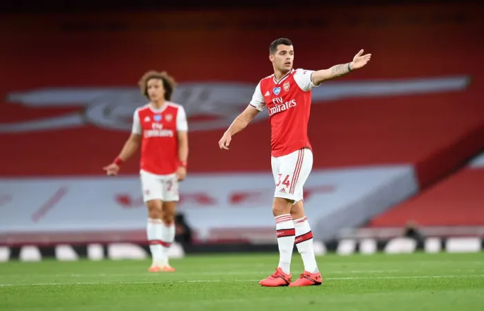 Framed Print : Empty Emirates: Granit Xhaka Faces Liverpool in Ghostly Premier League Arena (2019-2020)