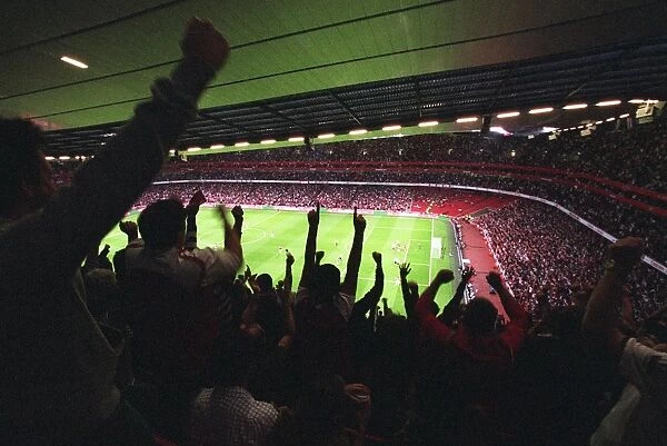 Emirates Stadium with fans cheering a goal