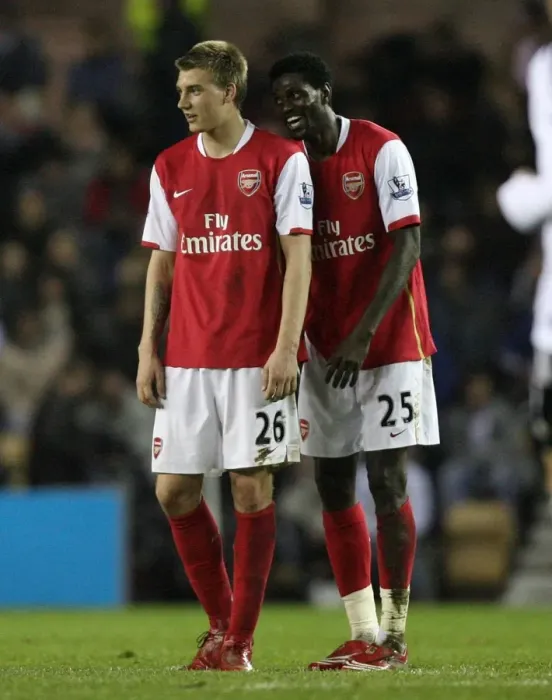 Framed Print : Emmanuel Adebayor (Arsenal) shares a joke with Nicklas Bendtner