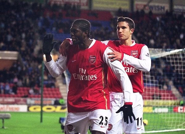 Emmanuel Adebayor celebrates scoring Arsenals goal with Robin van Persie