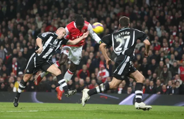 Framed Print : Emmanuel Adebayor heads past Stephen Carr to score the 1st Arsenal goal