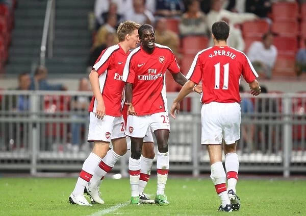 Emmanuel Adebayor and Robin van Persie celebrate Arsenal's