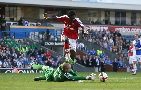 Emmanuel Adebayor shoots past Paul Robinson to score
