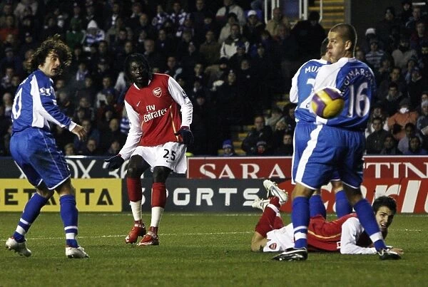 Emmanuel Adebayor shoots past Reading goalkeeper Marcus Hahnemann to score the 2nd Arsenal goal