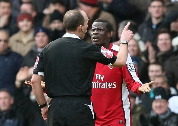 Emmanuel Eboue (Arsenal) argues with referee Mike Dean after being shwon the red card