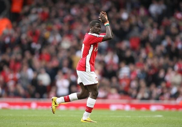 Emmanuel Eboue (Arsenal) claps the fans as he leaves the pitch