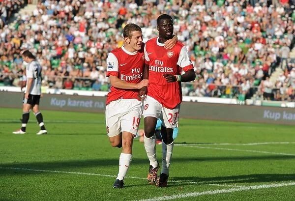 Emmanuel Eboue celebrates scoring the 3rd Arsenal goal with Jack Wilshere