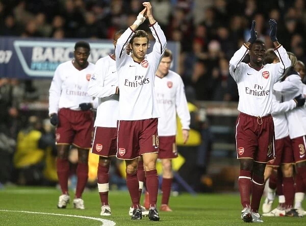 Emmanuel Eboue and Mathieu Flamini applaud the Arsenal fans before the match