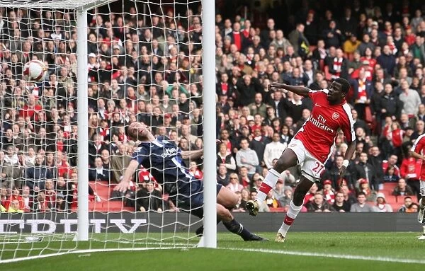 Emmanuel Eboue shoots past Andre Ooijer to score the 3rd Arsenal goal