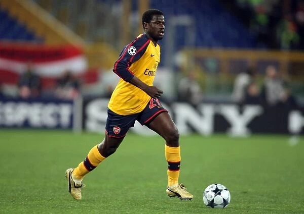 Emmanuel Eboue in a Tense Moment: Arsenal vs. AS Roma in the UEFA Champions League