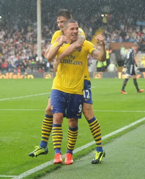 Framed Print : Euphoria Unleashed: Podolski and Giroud's Triumphant Moment as Arsenal Scores the Third Goal Against Fulham (2013-14)