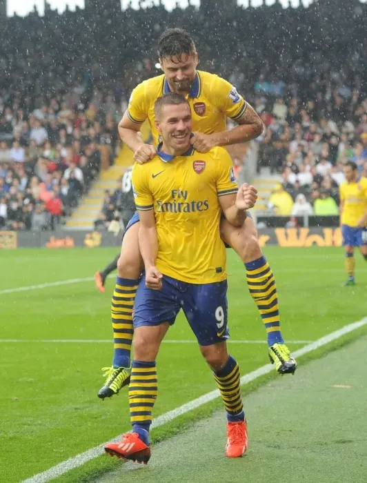 Framed Print : Euphoria Unleashed: Podolski and Giroud's Unforgettable Moment as Arsenal Scores the Third Goal Against Fulham (2013-14)