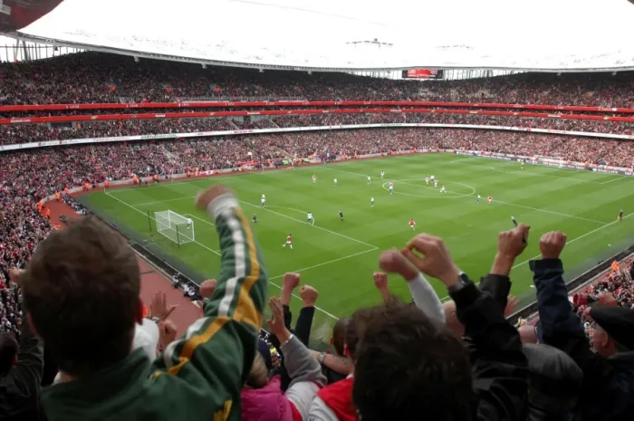 Framed Print : Fans jump up in the upper terrace to celebrate Emmanuel Adebayor scoring Arsenals 1st goal Framed Print : Fans jump up in the upper terrace to celebrate Emmanuel Adebayor scoring Arsenals 1st goal